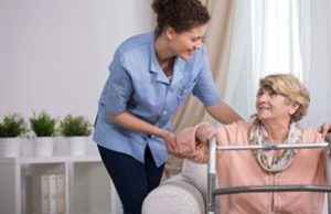caregiver helping an elderly woman
